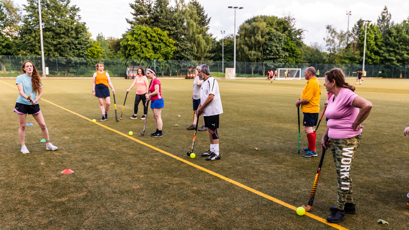 Adults at a community walking hockey session